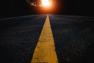 Surface level of empty road at sunset