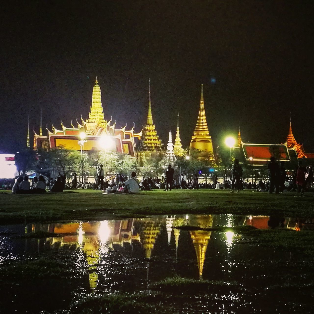 illuminated, building exterior, architecture, built structure, place of worship, night, religion, tourism, spirituality, travel destinations, famous place, reflection, travel, water, temple - building, in front of, culture, outdoors, architectural feature, sky, spire, vacations, international landmark