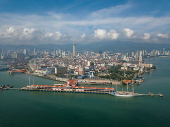 Scenic view of sea and city against sky