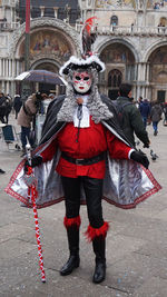 Full length portrait of man standing on mask