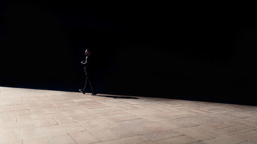 Side view of a man standing on footpath