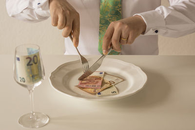Close-up of man preparing food on table