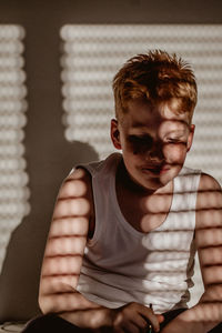 Portrait of teenage boy sitting at home