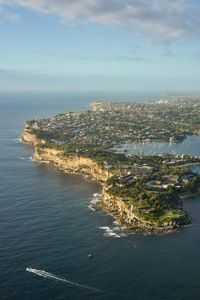 High angle view of sea and cityscape against sky