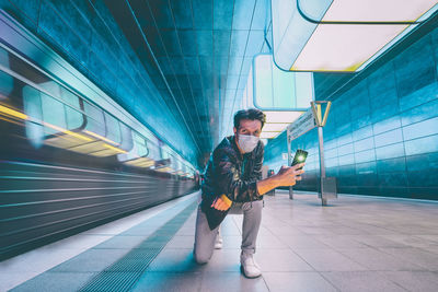 Man waiting at railroad station platform