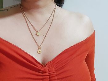 Close-up of woman wearing hat against gray background