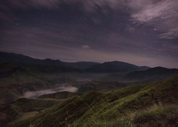 Scenic view of landscape against sky at night