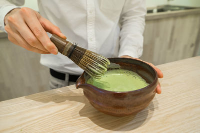 Close-up of person preparing food on table
