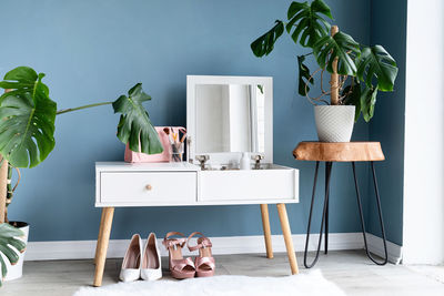 Stylish room interior with elegant dressing table and plants