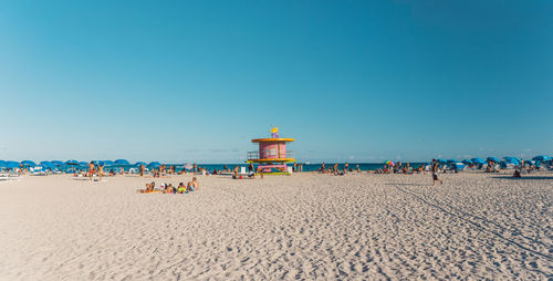 Scenic view of beach against clear blue sky