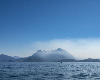 Scenic view of mountains against blue sky