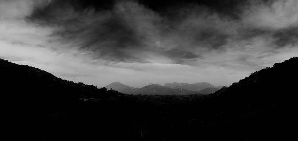 Scenic view of silhouette mountains against sky