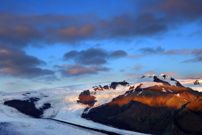 Scenic view of snowcapped mountains against sky during sunset