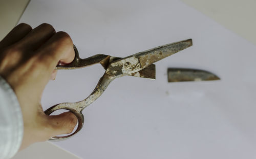 Close-up of hand holding chain against clear sky