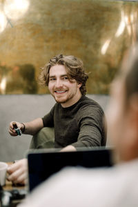 Portrait of smiling business person sitting in office