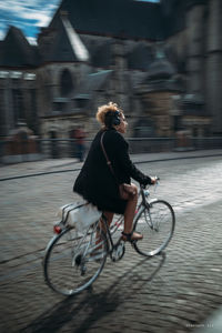 Man riding bicycle on city street