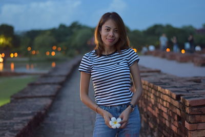 Smiling young woman at park