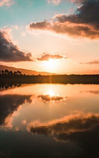 Scenic view of calm lake at sunset