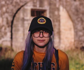 Portrait of young woman wearing sunglasses standing outdoors