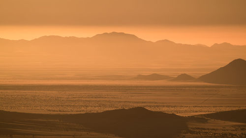 Scenic view of silhouette landscape against sky during sunset