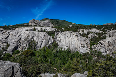 Scenic view of rocky mountains against clear blue sky