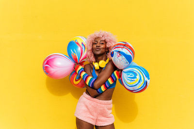 Portrait of young woman with balloons