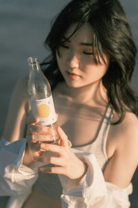 Young woman drinking glass