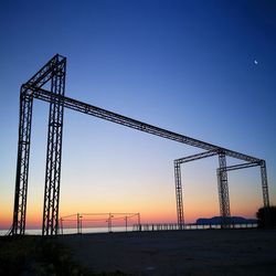 Low angle view of crane against clear sky