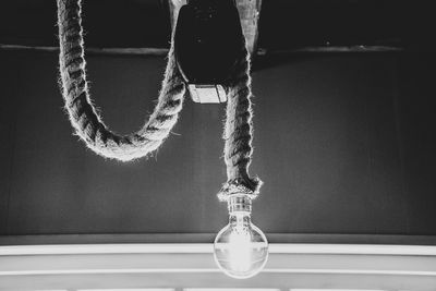 Close-up of ropes hanging on rope against wall