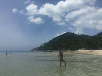 Man on beach against sky