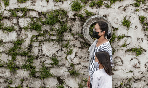 Woman standing against wall