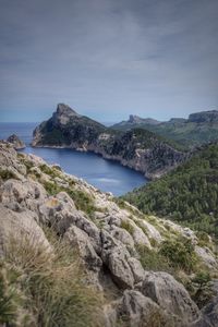 Idyllic view of mountains by sea against sky