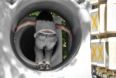 Rear view of girl on playing equipment