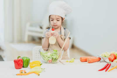 Young woman holding food on table
