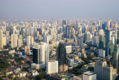 High angle view of modern buildings in city against sky