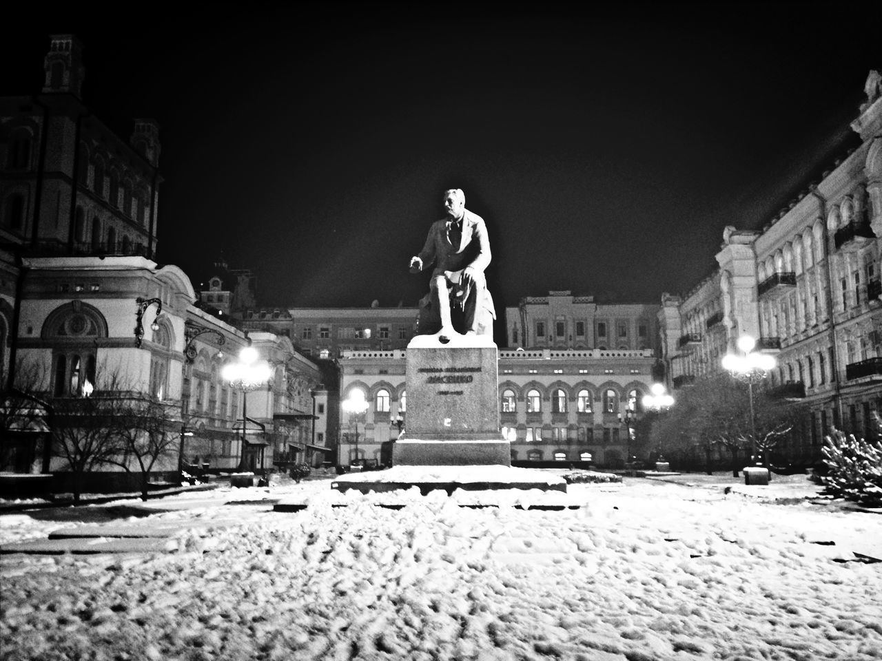 building exterior, architecture, night, built structure, illuminated, snow, winter, cold temperature, street, street light, residential structure, statue, residential building, city, art and craft, house, human representation, outdoors, season, building