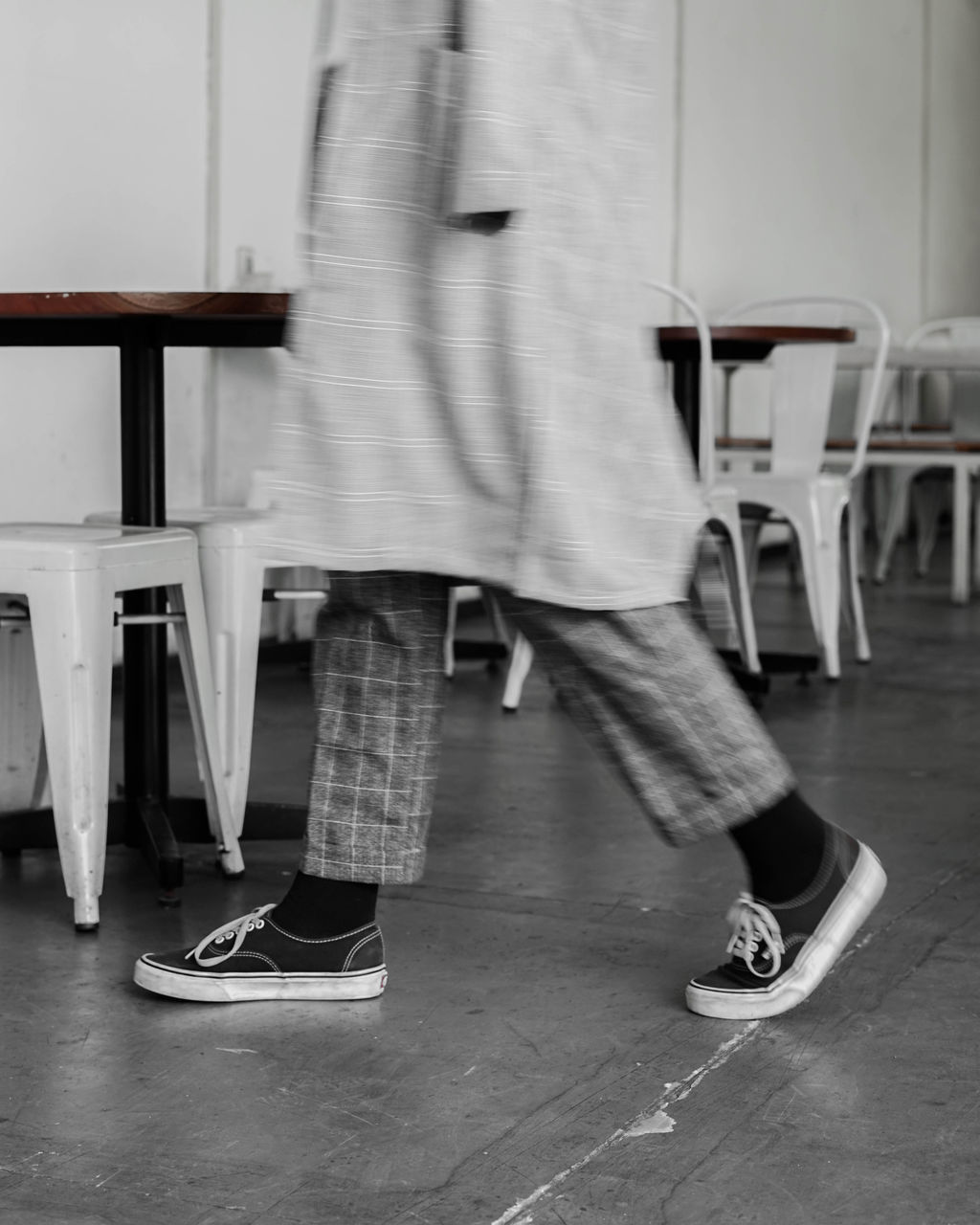 LOW SECTION OF MAN STANDING ON CHAIR IN ABANDONED BUILDING