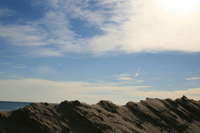 Low angle view of rock formation in sea against sky
