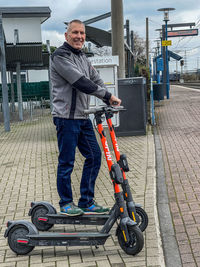 Full length portrait of man skateboarding on motorcycle