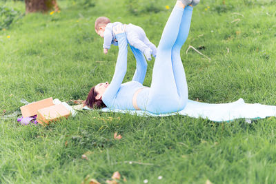 Side view of woman lying on field
