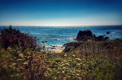 Scenic view of sea against clear blue sky