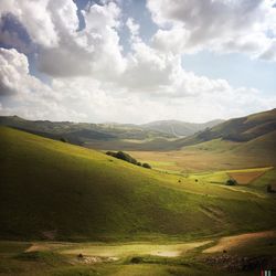 Scenic view of mountains against cloudy sky