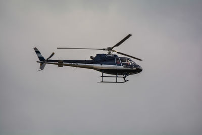 Low angle view of helicopter against sky