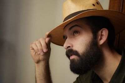 Close-up portrait of man wearing hat