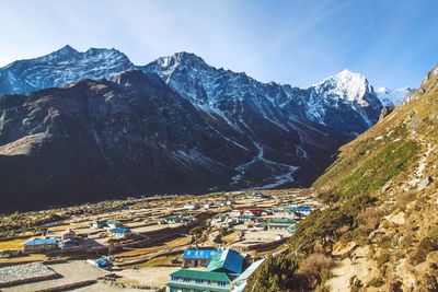 High angle view of village in valley against sky