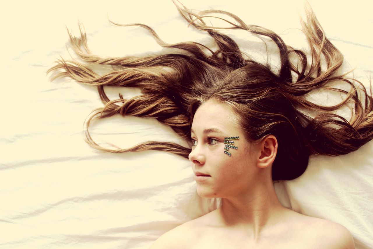PORTRAIT OF WOMAN LYING ON BED