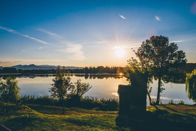 Scenic view of lake against sky during sunset