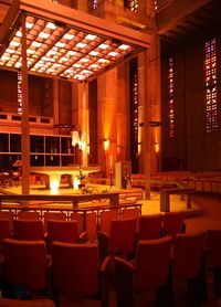 Empty chairs and tables in restaurant at night