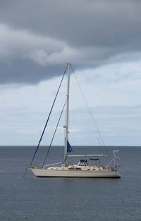 Sailboat sailing on sea against sky