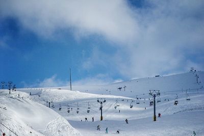 High angle view of ski lift over snow covered mountains against sky